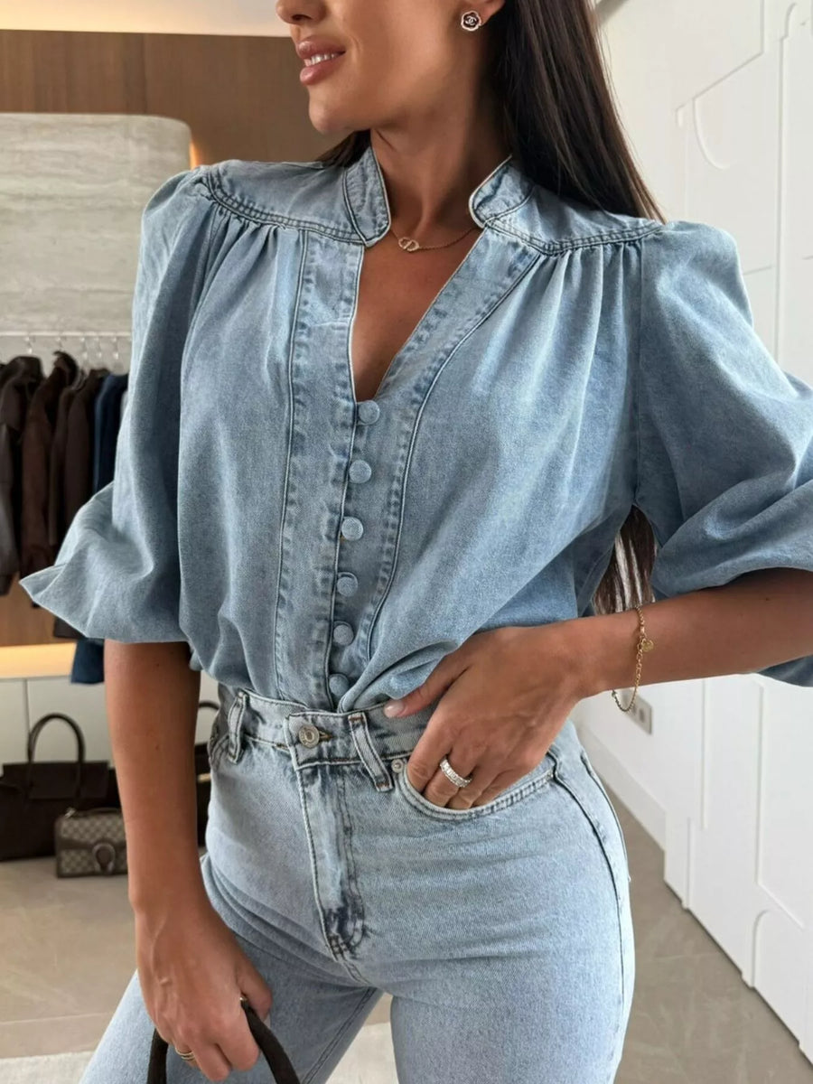 Button-down puff sleeve denim blouse in sky blue with a V-neck and gathered shoulders.