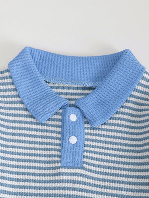 Children's blue and white striped polo shirt with waffle knit texture and two white buttons.