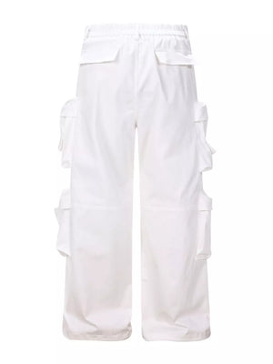 White cargo pants with multiple flap pockets and a relaxed fit.