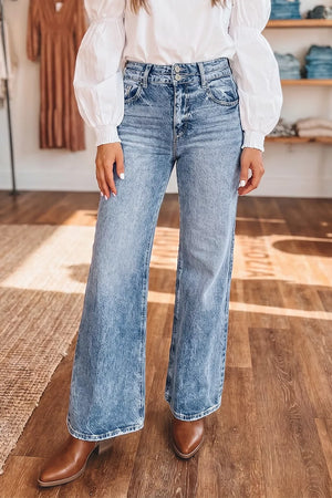 Light wash wide leg denim jeans with a high waist and button fly.