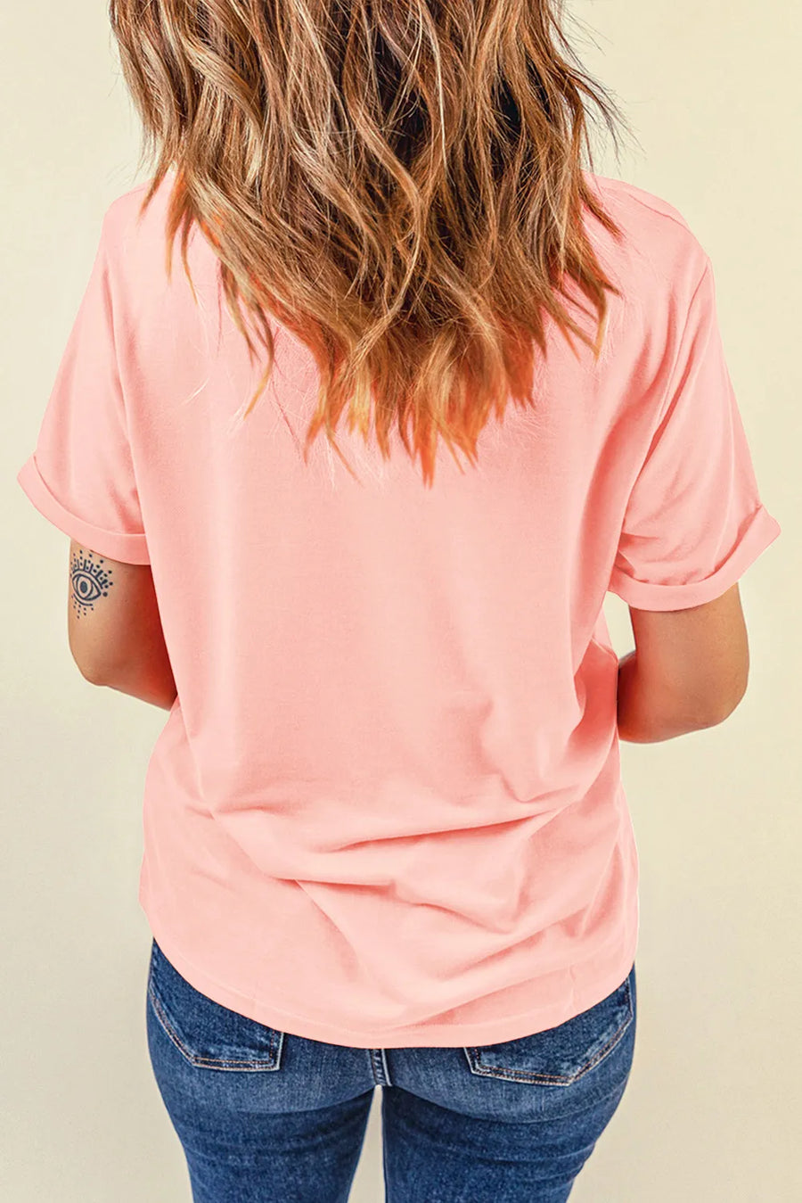 Blush pink casual t-shirt with cuffed short sleeves and a graphic detail on the left arm.