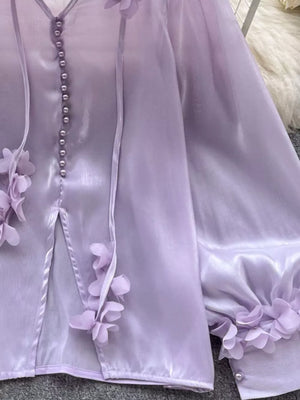 Purple sheer button-down shirt with delicate floral appliqués on cuffs and placket.