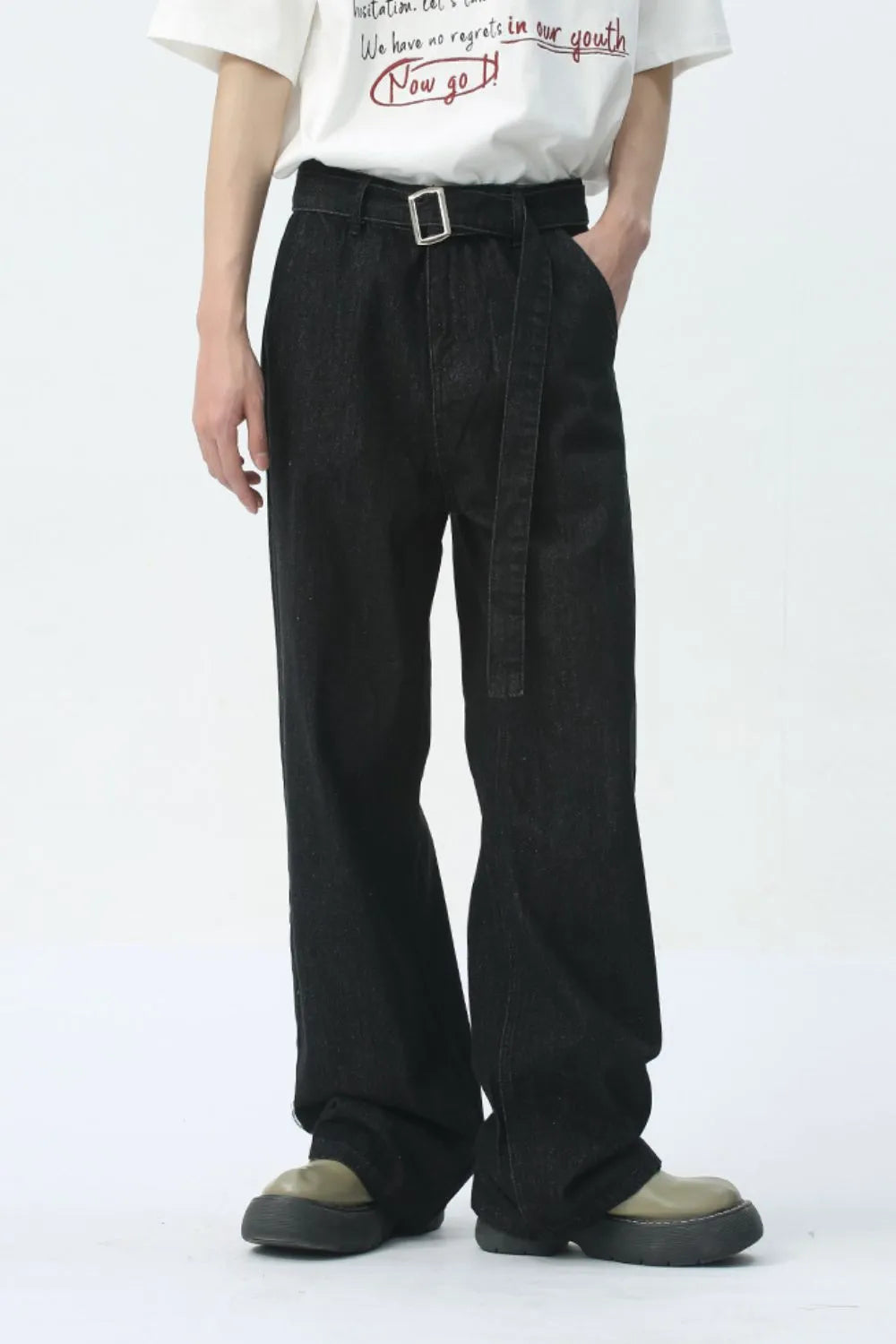 Black wide-leg denim jeans with belt detail and silver buckle.