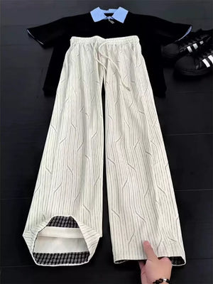 wide-leg pants in cream featuring drawstring waist and wide-leg fit