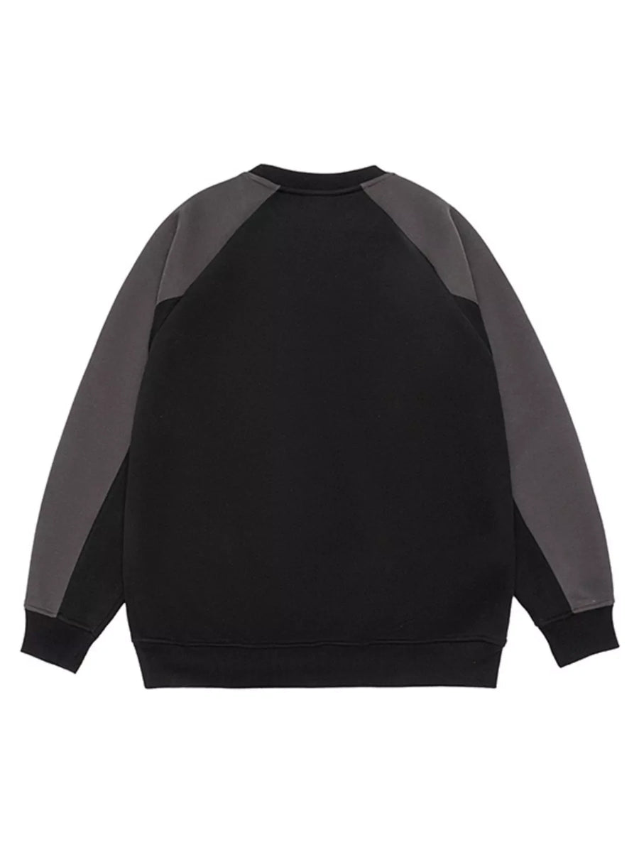 Black oversized raglan sleeve sweatshirt with gray paneling on sleeves.