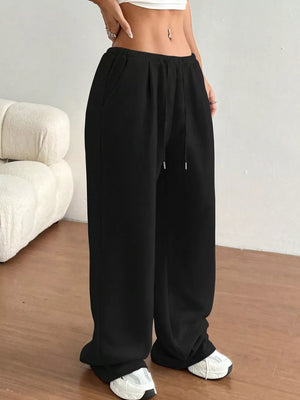 Black wide-leg maternity joggers with drawstring waist and pockets.