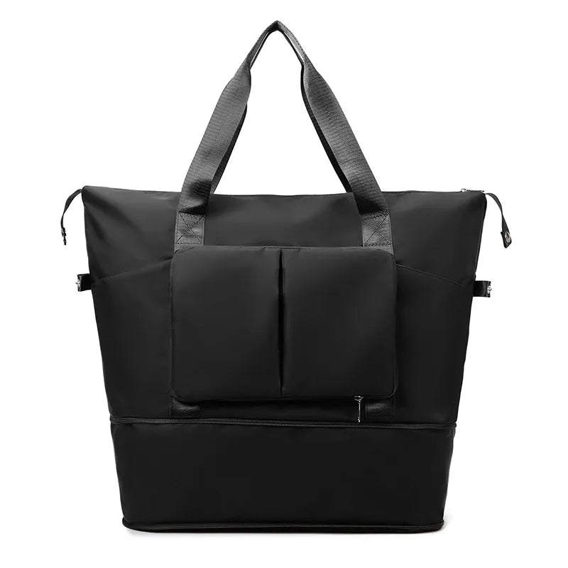 Black foldable travel tote with dual exterior pockets and top handles.