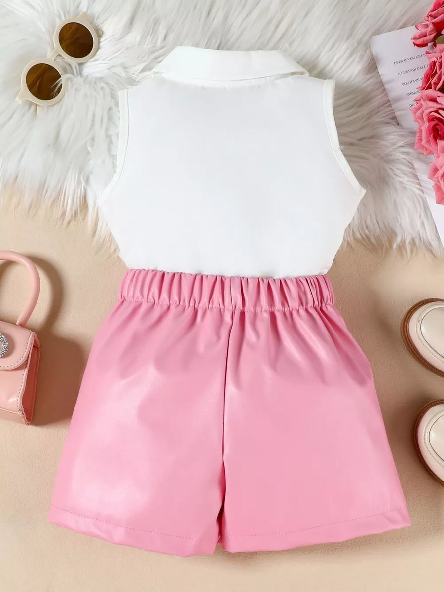 Pink faux leather shorts with elastic waist and white collared sleeveless top.