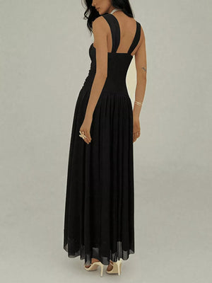 Black ruched sleeveless maxi dress with a-line skirt and embellishments.