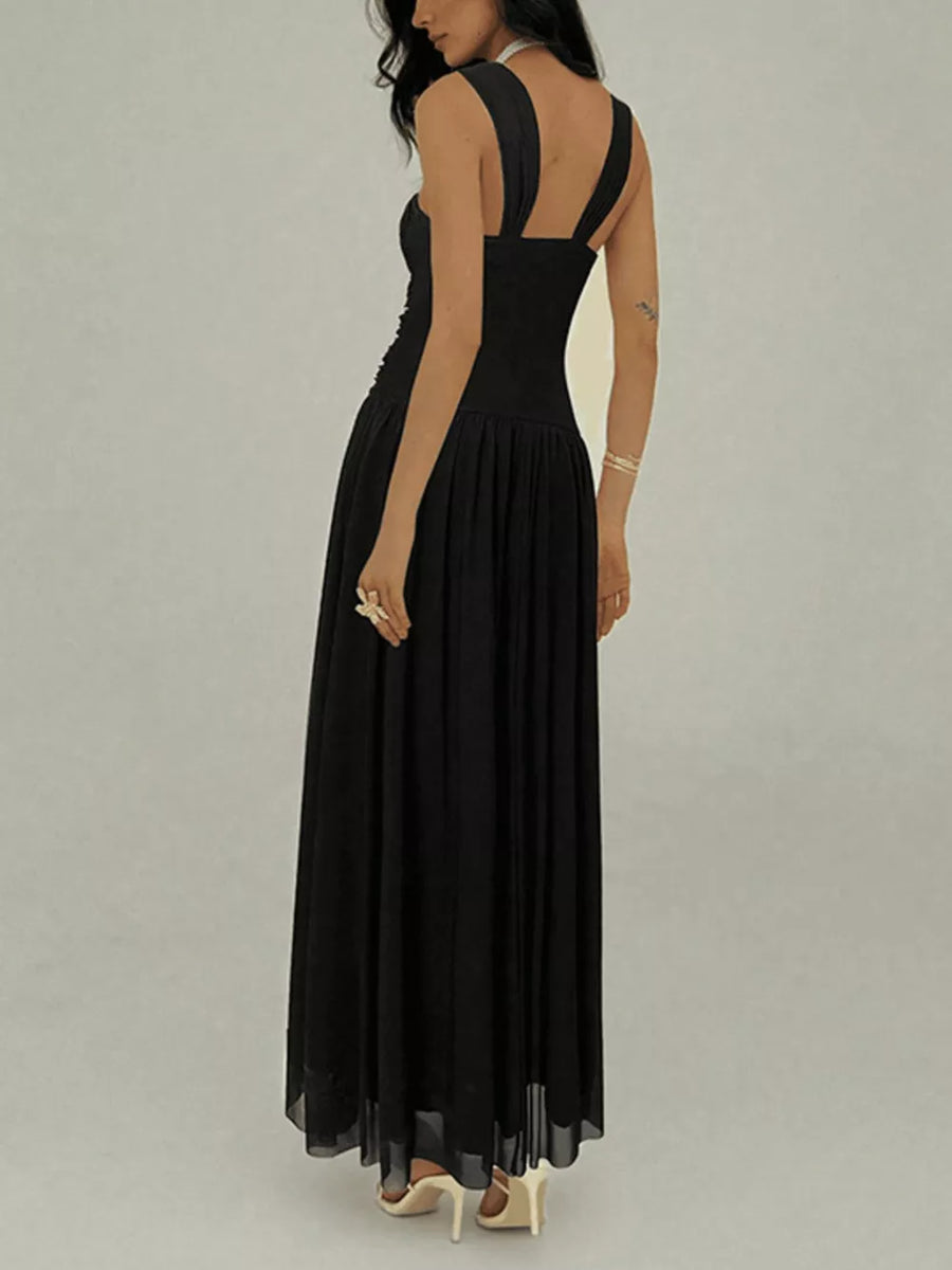 Black ruched sleeveless maxi dress with a-line skirt and embellishments.
