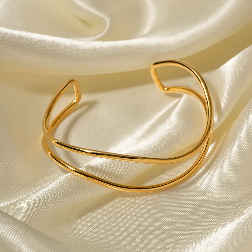 Gold double-band cuff bracelet with a smooth, polished finish.