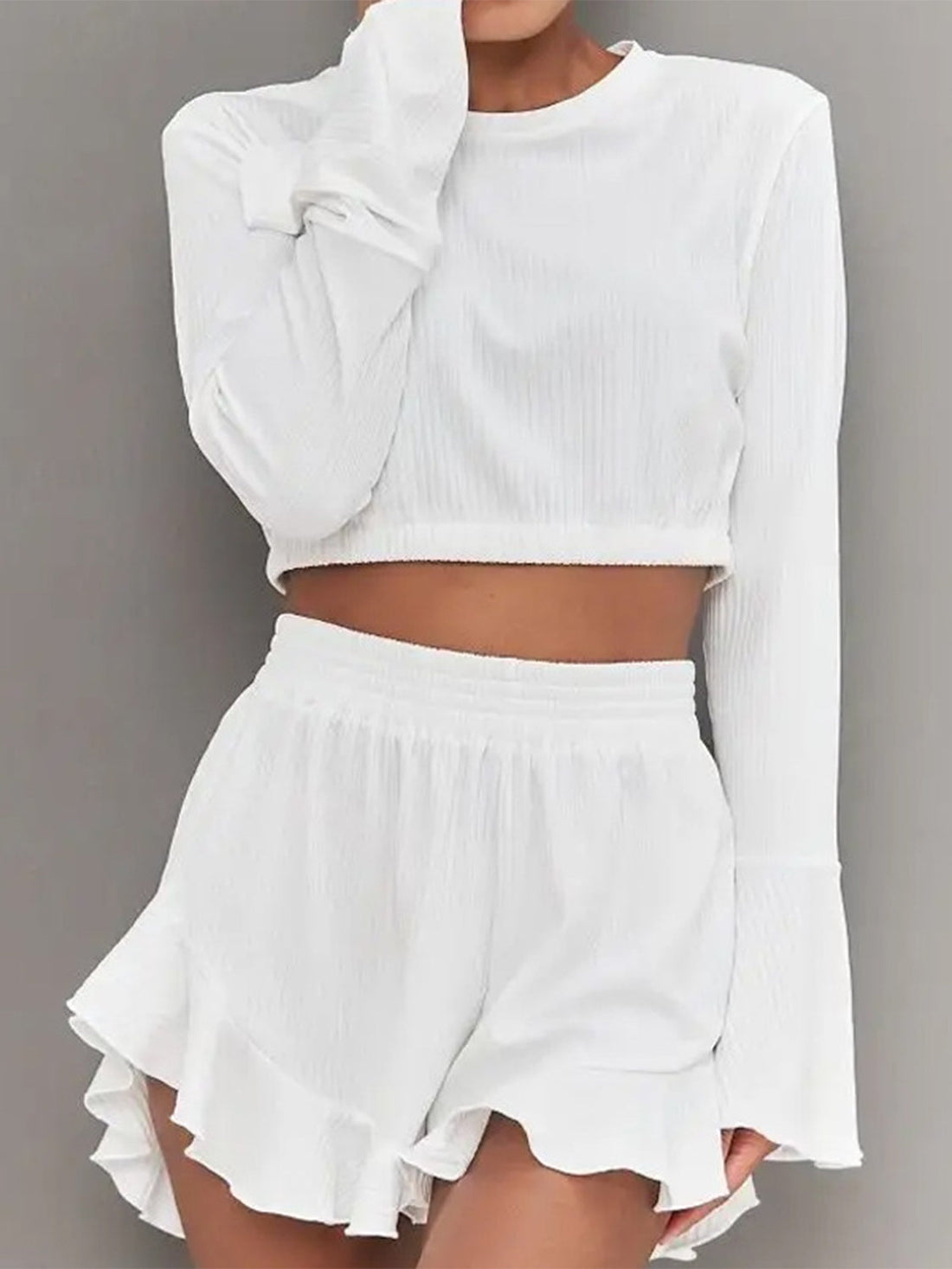 White ribbed crop set with flared sleeves and ruffled shorts