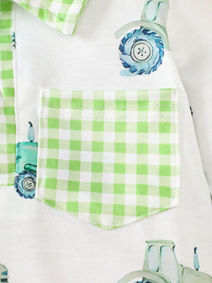 Baby one-piece with tractor print and green gingham trim pocket and collar detail.