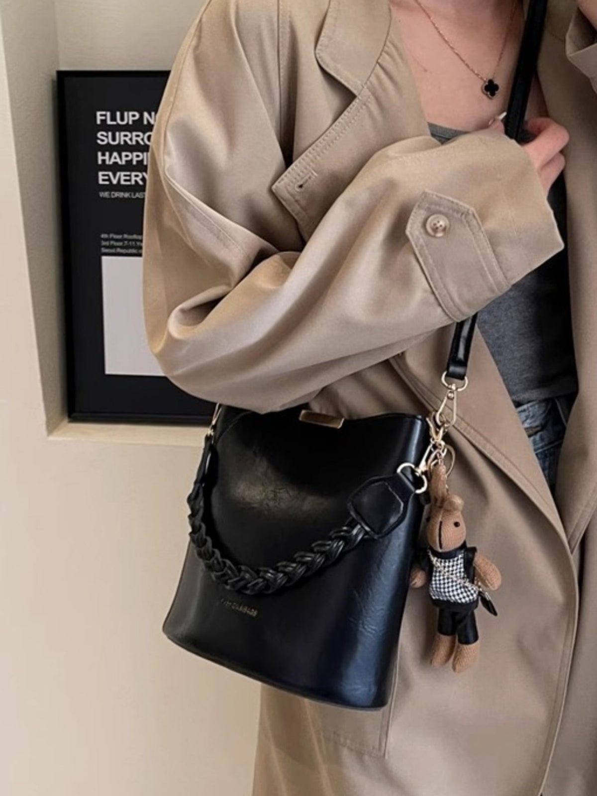 Black braided bucket crossbody bag with a bunny charm