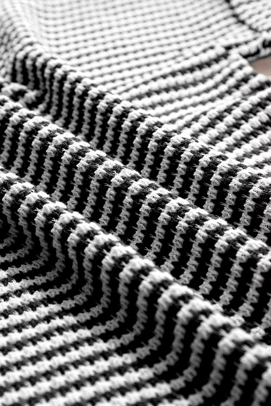Textured knit t-shirt in black and white with a notched neckline.