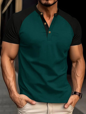 Dark green raglan henley polo shirt with black sleeves and gold button detail