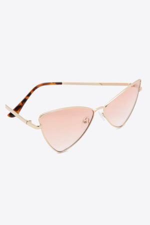 Angular cat-eye sunglasses with gradient lenses and gold frames.