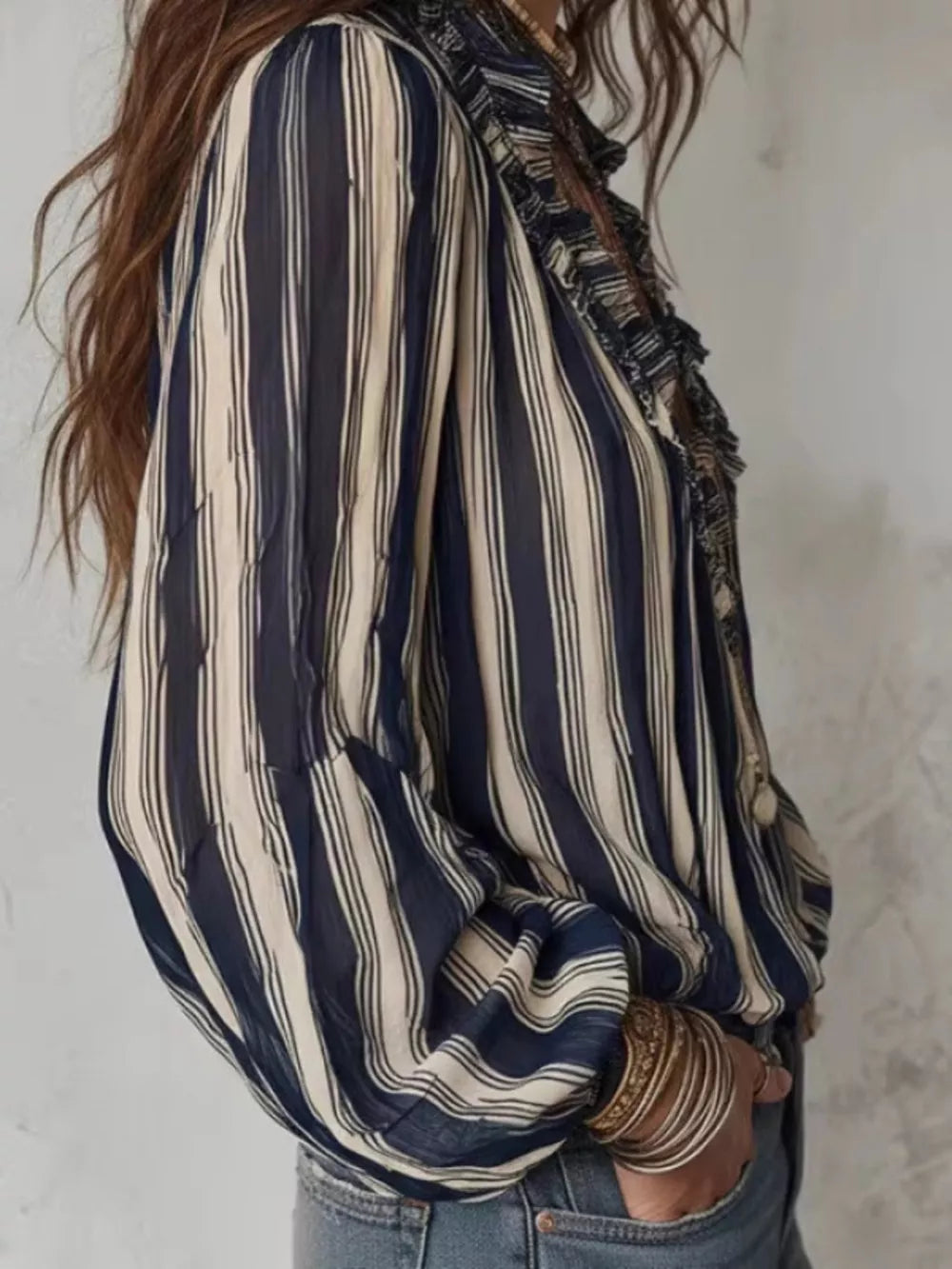 ivory blouse featuring ruffled and striped