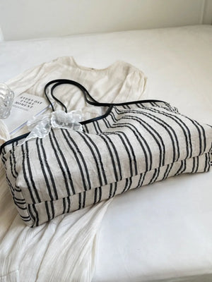 Beige shopper bag with black stripes and lace bow detail
