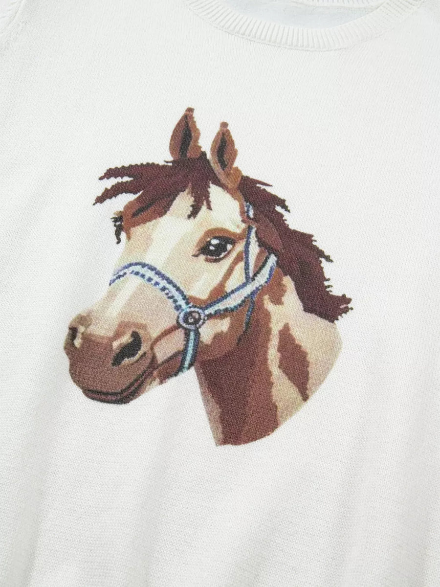 White acrylic sweater with a brown horse head graphic and blue halter detail.