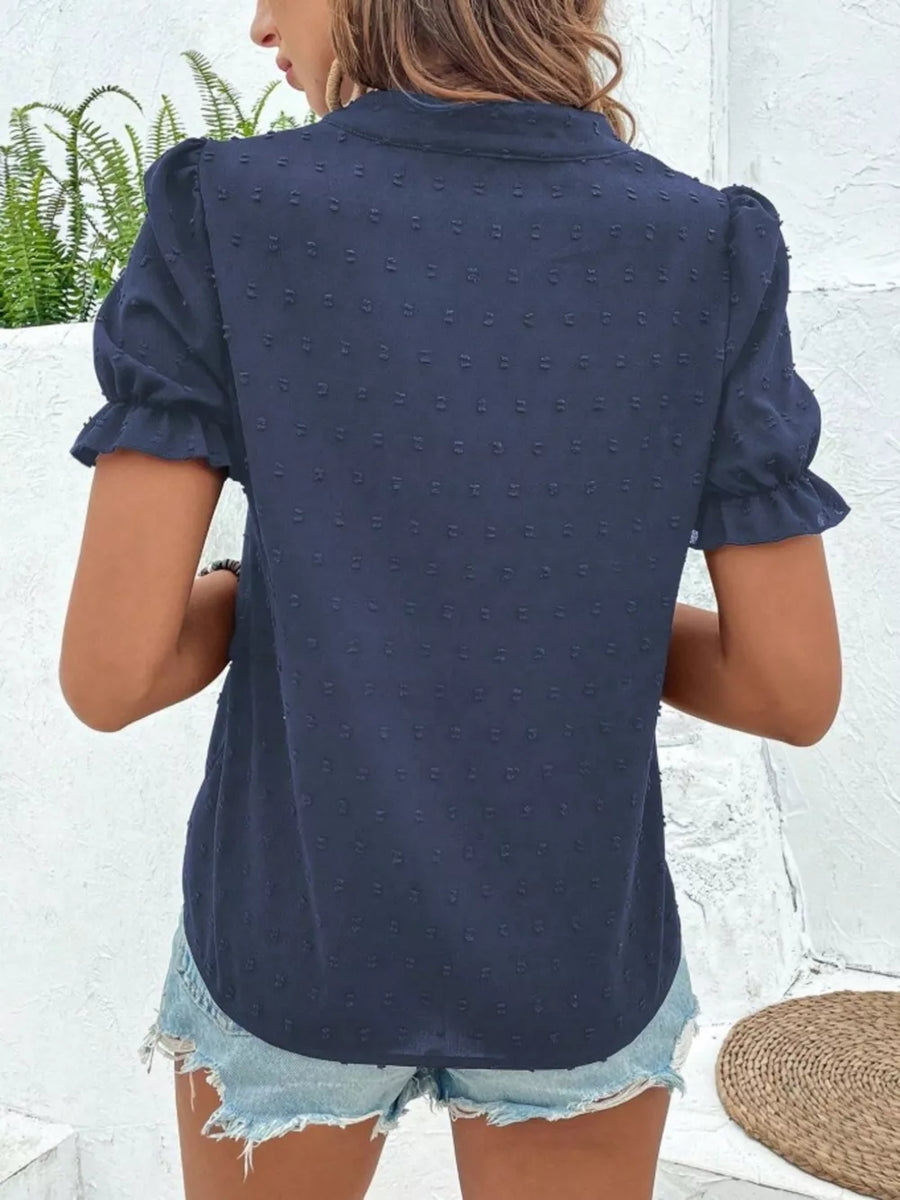 Navy blue textured puff sleeve blouse with ruffled cuffs and a collared neckline.