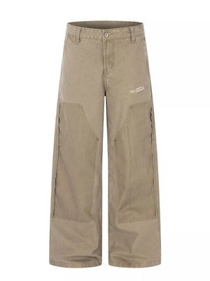 Khaki wide-leg cargo pants with distressed details and deconstructed seams.