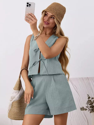 Blue cotton tie-front sleeveless top and pleated shorts set with a V-neck.