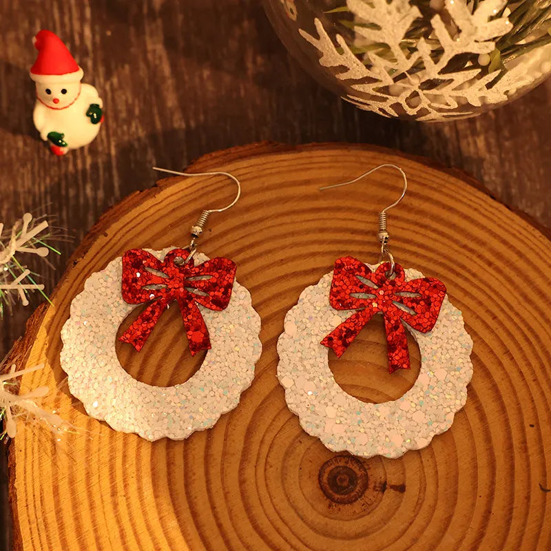 Glitter wreath drop earrings in white with red bows.