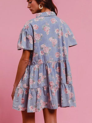 Light blue floral denim mini dress with ruffled tiers and short puff sleeves.