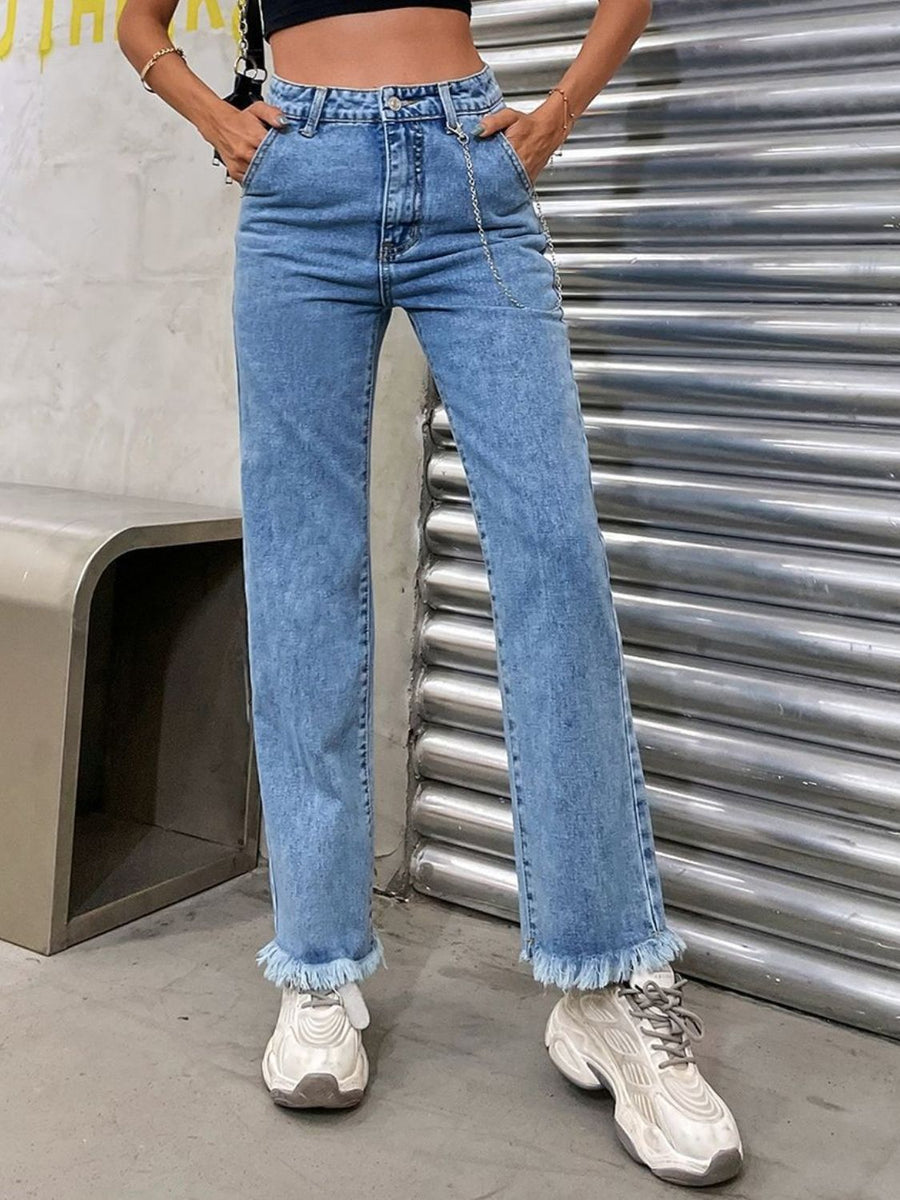 Light wash denim jeans with chain detail and frayed hem