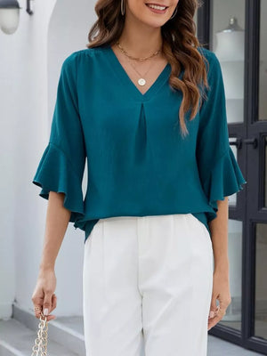 Teal V-neck blouse with ruffle sleeves and a subtle pleat detail.