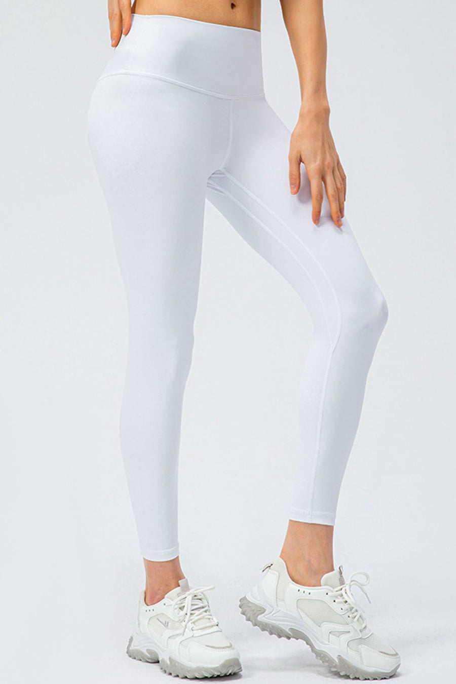 White high-rise performance leggings with sculpted seams and a breathable fit.