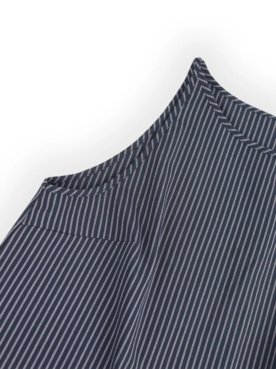 Blue striped sleeveless top detail with sharp shoulder seam and pocket flap.