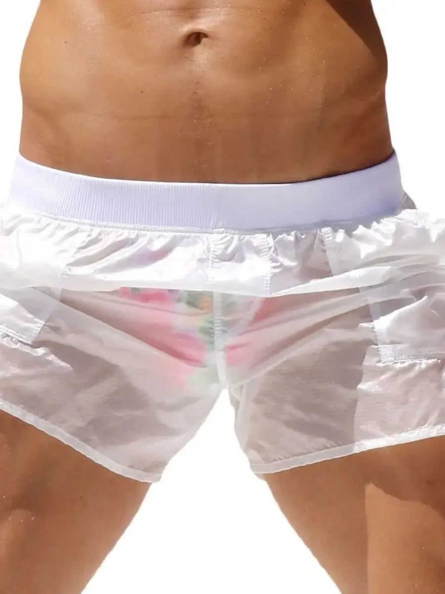 White sheer swim shorts with pocket detail and floral print briefs underneath