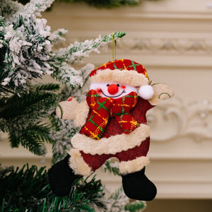 Red fabric Christmas ornament of a cheerful snowman character with a plaid scarf and hat.