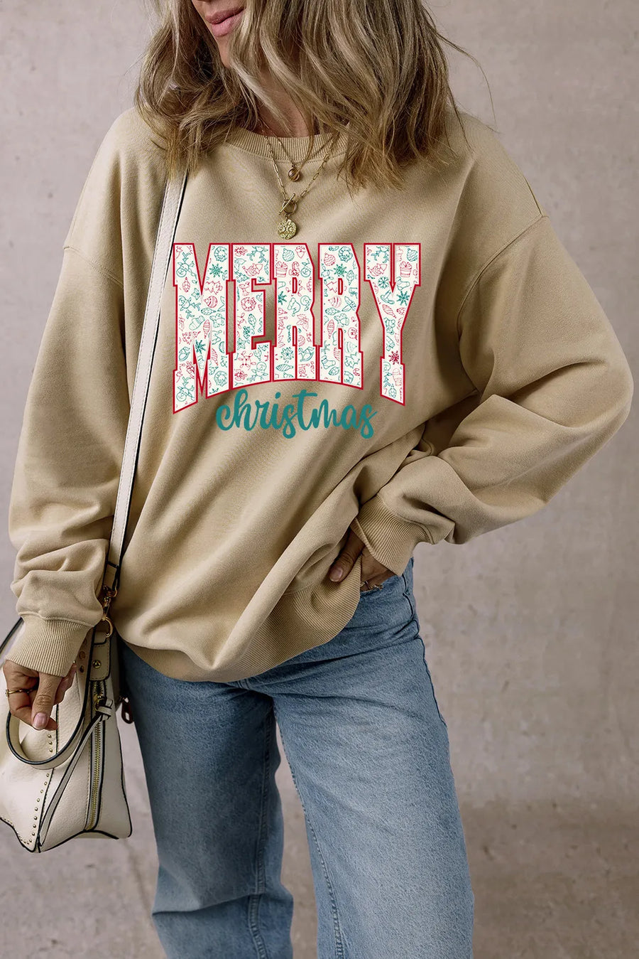 Khaki long sleeve sweatshirt with "MERRY christmas" graphic and festive pattern.