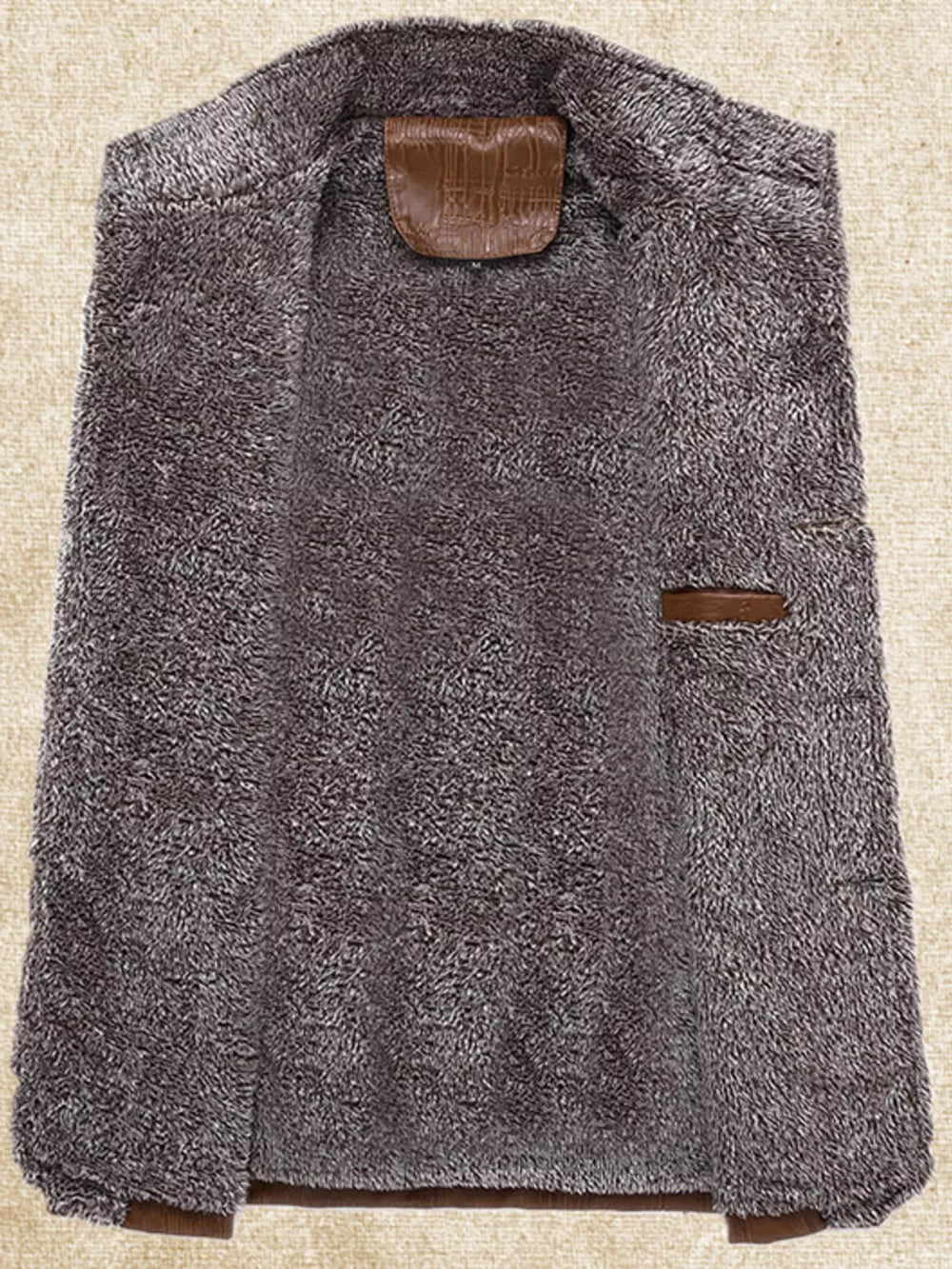 Men's grey fleece lined sport jacket interior with brown leather details.