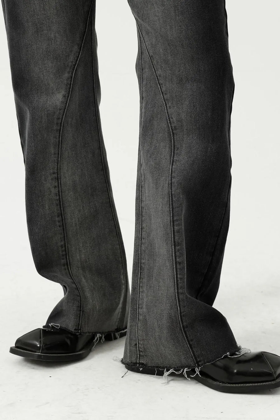 Dark wash cotton flare jeans with seam detail and raw hem