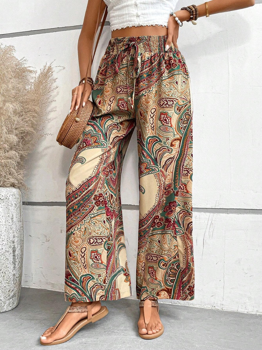 Paisley palazzo trousers with drawstring waist in multicolor, featuring a relaxed fit and wide leg.