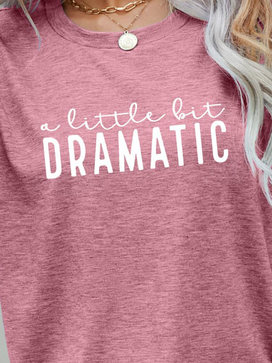 Blush pink crew neck tee with white "a little bit DRAMATIC" graphic print.