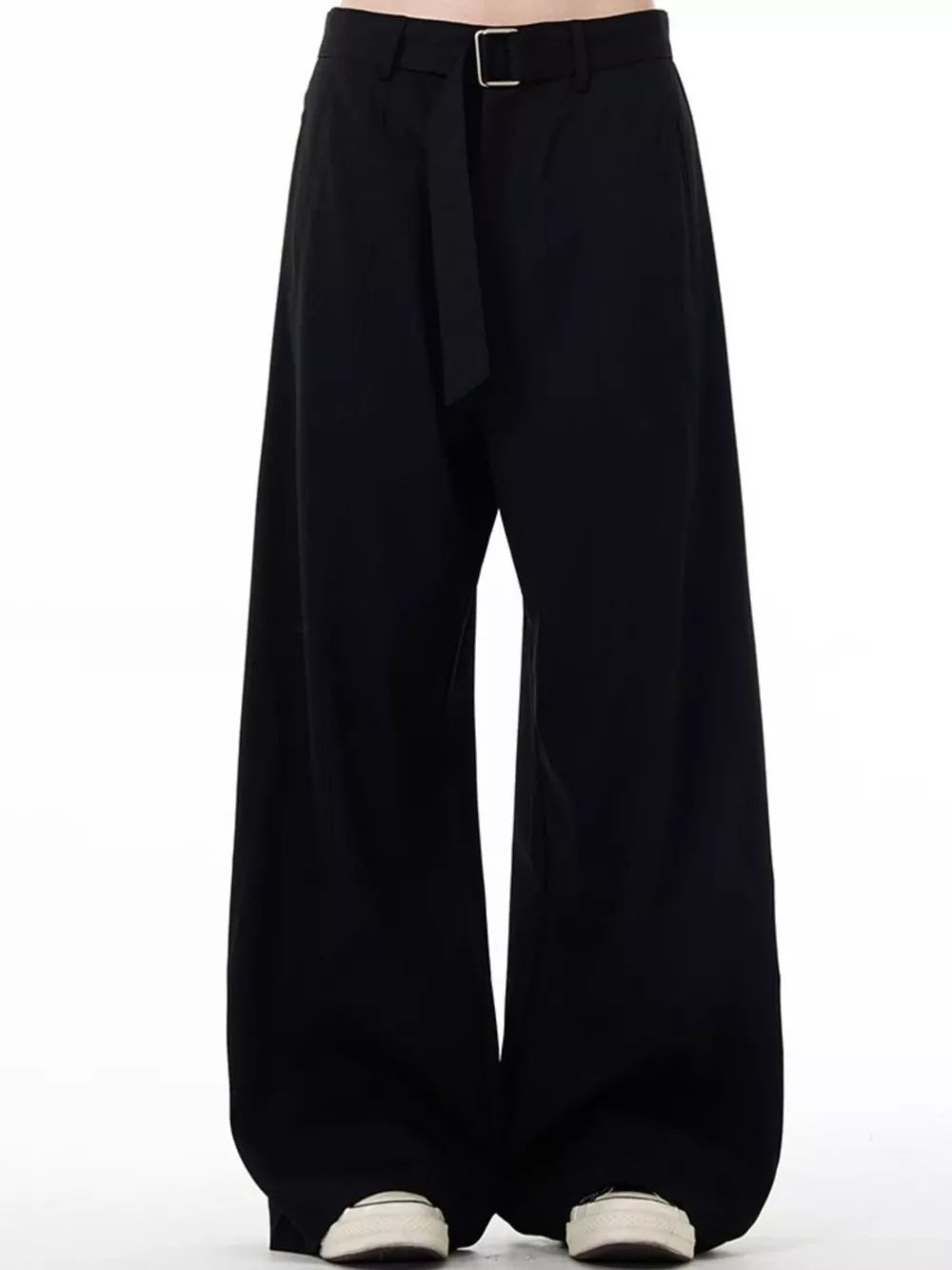 Men's black wide-leg sweatpants with belt detail and casual sneakers.