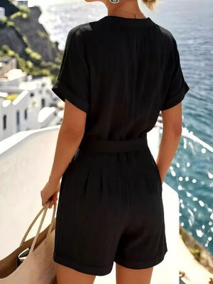Black buttoned shirt and shorts set with cuffed sleeves and shorts, belted waist.