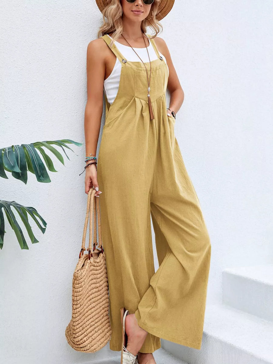Light Yellow wide-leg romper with pockets and adjustable straps, styled with a white tank top.