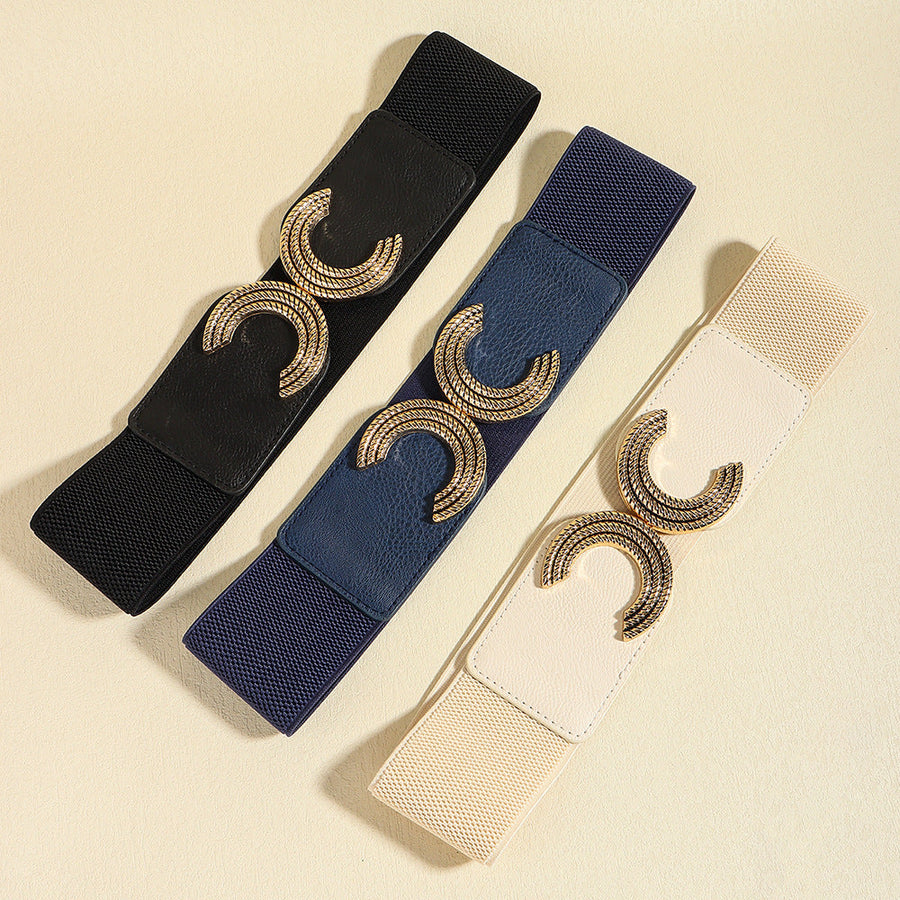 Black, dark blue, and ivory stretch belts with double C gold buckle detail