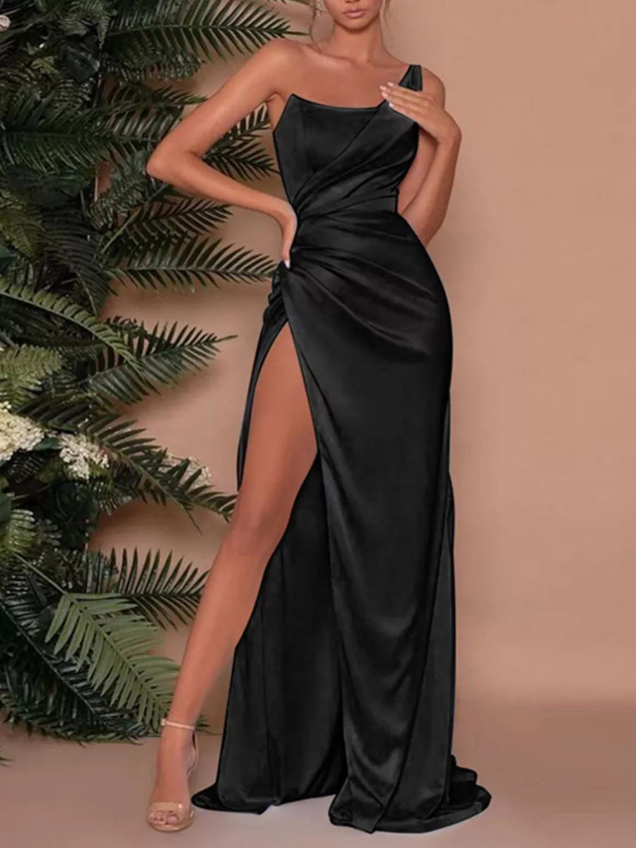Black one-shoulder ruched maxi dress with a high slit and draped bodice.