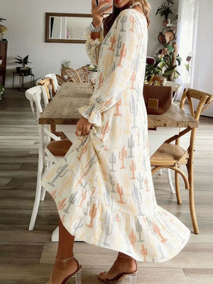 White dress with cactus print, long sleeves, and ruffled hem