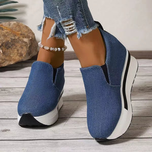 Blue denim slip-on shoes with round toe and chunky platform sole.