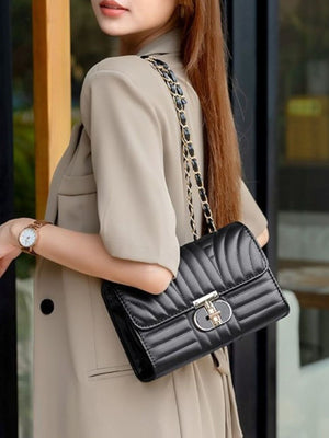 Black crossbody bag featuring quilted and quilted