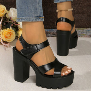 Black open-toe block heel sandals with chunky platform sole and ankle strap.