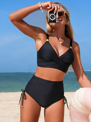 Black high-waisted bikini bottoms with drawstring sides and gold accents.